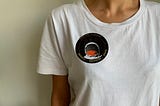 mission sticker on a white tee-shirt