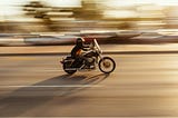 Time-lapse photography of a man riding a motorcycle