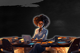 a woman with dark skin and curly hair wearing glasses, seated at a desk in a dimly lit room, illuminated by the soft glow of her laptop screen. Papers and digital devices are spread out on the table, suggesting a busy work environment. The woman appears focused and engaged with her work, possibly coding or analyzing data, as indicated by the graphical elements on her laptop screen. The setting conveys a late-night work atmosphere with a sense of calm concentration.