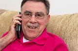 senior man happily talking on the phone — staying connected safely