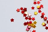 Selective-focus-photography of assorted red and gold cutout stars