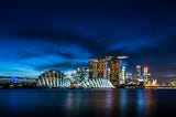 a dark sky over Singapore cityscape with lit iconic buildings