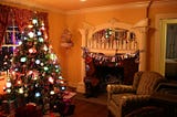A Christmas tree fully decorated in a living room long past the holidays