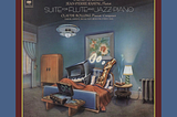 Album cover for Claude Bolling’s “Suite for Flute and Jazz Piano” showing a flute blowing smoke rings from a cigarette while lying in bed with an exhausted piano.