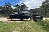 Caravan and car set up at campsite