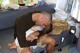 Man holding babyson in hospital