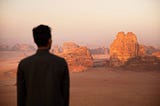 A man standing in front of a desert