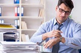 A busy man at work struggling to improve productivity.