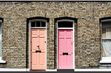 The writer pictures two exterior doors, one pink and one orange.