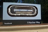 Facebook HQ’s iconic ‘1 Hacker Way’ sign. The Facebook logo has been replaced with a giant USB C port. Image: D-Kuru (modified) https://commons.wikimedia.org/wiki/File:MSI_Bravo_17_(0017FK-007)-USB-C_port_large_PNr%C2%B00761.jpg Minette Lontsie (modified) https://commons.wikimedia.org/wiki/File:Facebook_Headquarters.jpg CC BY-SA 4.0 https://creativecommons.org/licenses/by-sa/4.0/deed.en