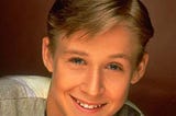 A picture of the beloved Canadian actor Ryan Gosling as a young boychild, giving the camera a million dollar smile. Adorable.
