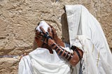 A Jewish boy and his father wearing Tefillin