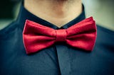 Red bow tie with black shirt closeup