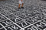 Person standing on grid of numbers