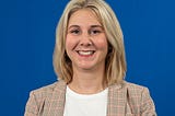 Jean Winsor headshot against a blue background