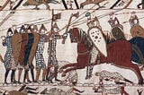 Part of scene 52 of the Bayeux Tapestry. This depicts mounted Normans attacking the Anglo-Saxon infantry.