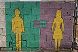 A graffiti on a wall showing a man silhouette and a woman silhouette with an equal sign inbetween.