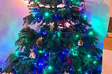 A Christmas tree with green and blue lights