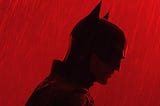 silhoute of batman amidst a red glow and rain