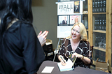 Kim Ann Curtin signing her book Transforming Wall Street