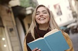 A girl Smiling with a book