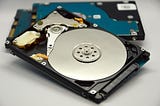 How should you safely dispose of an old hard drive?