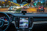 Car camera installed on dashboard and view of front camera on display.