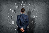 A man in front of a clock