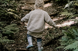 little child running through forest