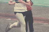 The author, running on a the track, competing in a race back in her younger days.