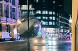 A giant, inflated silver ball, several times taller than a car, is shown rolling down a London street in a viral TikTok video.