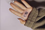 Ariana Grande and her Japanese BBQ grill finger tattoo