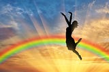 Happy Woman Jumping Near Rainbow