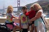 Author and her three grandchildren standing in front of the Golden Gate Bridge in Sausalito, California.