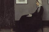 Whistler’s mother sitting in a chair facing left, hands in lap and a painting on the wall.