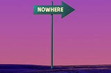 A green sign with the word ‘Nowhere’ is silhouetted against a purple sky.