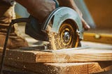 Circular saw cutting wood board