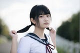 Japanese girl holding ponytails.