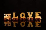 wooden train wagons as letters ‘love’