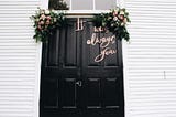 A front door with the lettering “It was always you.”