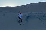 Image of me skiing down a small sand dune.