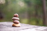 Four small rocks stacked atop each other