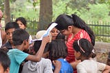 Photo : This was captured with me in the frame in a small slum in Hisar (Haryana) surrounded by enthusiastic young children learning how to draw and colour. Age group of children ranged from 5–15 years old.