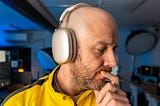 Side profile of Mark Ellis listening to his AirPods Max, seemingly contemplating the sound