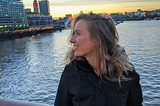 Lola standing on Blackfriars Bridge at sunset.