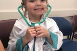 Photo of my then five-year-old daughter dressed as a doctor.