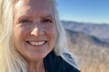 Picture of me after hiking to the top of the mountains where I live — smiling.
