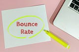 Sticky note with the words bounce rate circled with a yellow highlighter next to lap top.