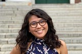 Isabel Yap, author of Never Have I Ever, standing in front of a building at Harvard.