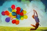 Boy holding colored balloons
